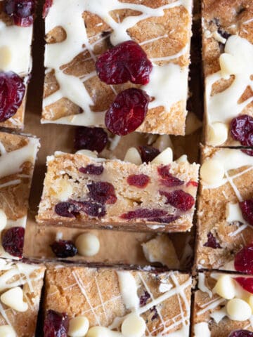 White chocolate cranberry blondies cut into bars.