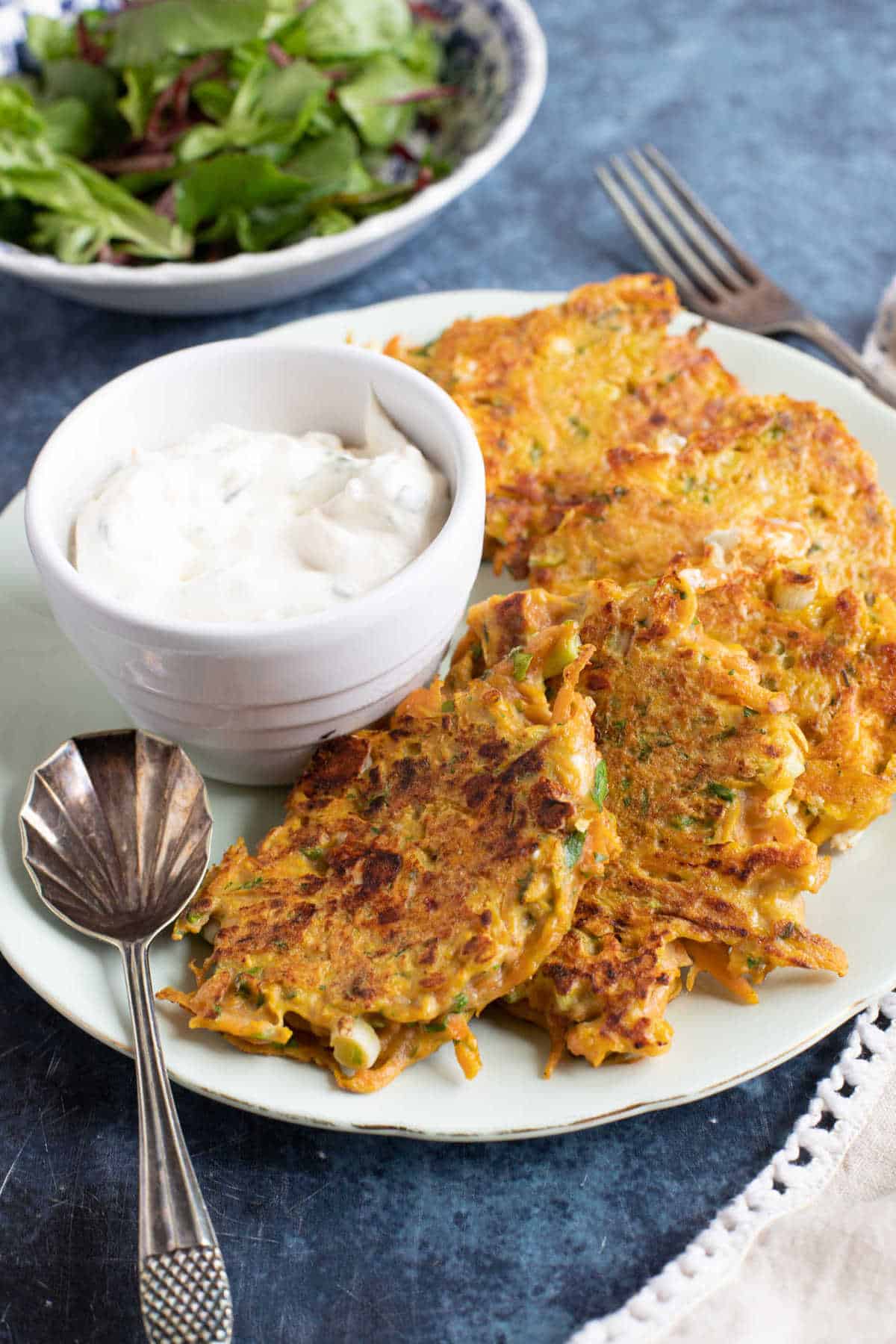 Easy carrot fritters with a sour cream dip and salad.