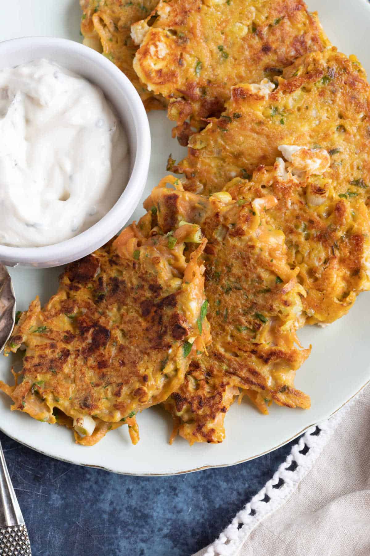 A plate of carrot, feta and coriander fritters.