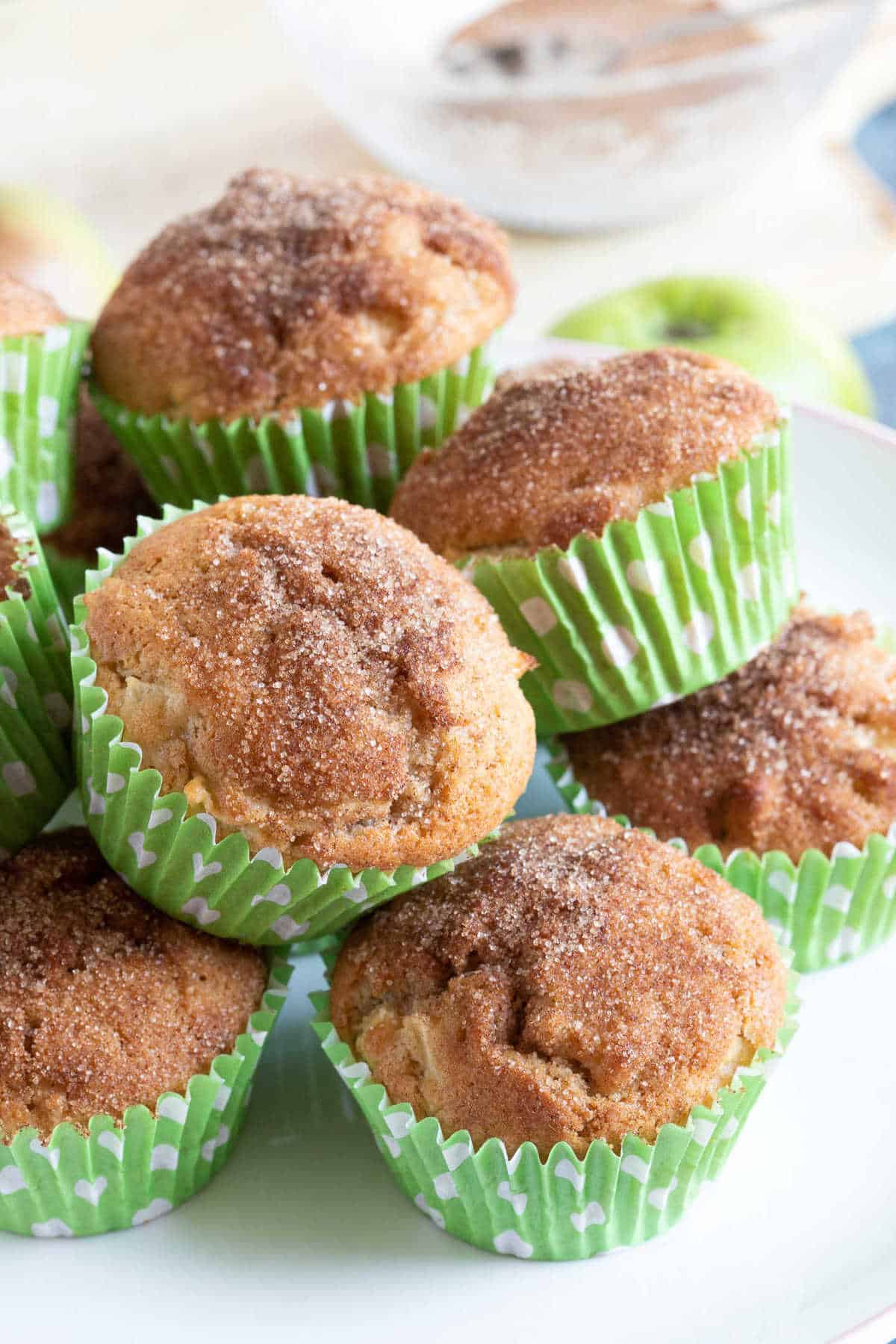 Cinnamon apple muffins on a cake stand.