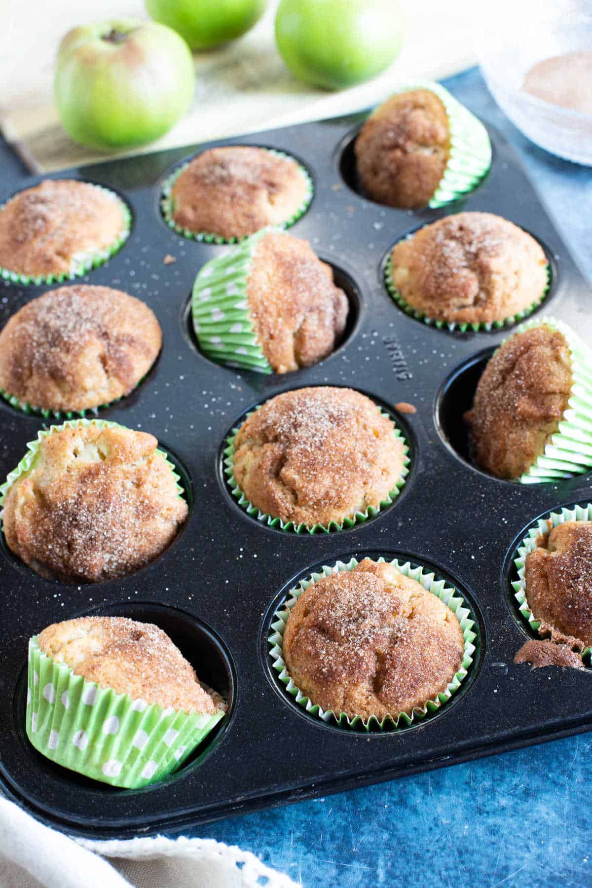 Cinnamon apple muffins in a muffin tin.