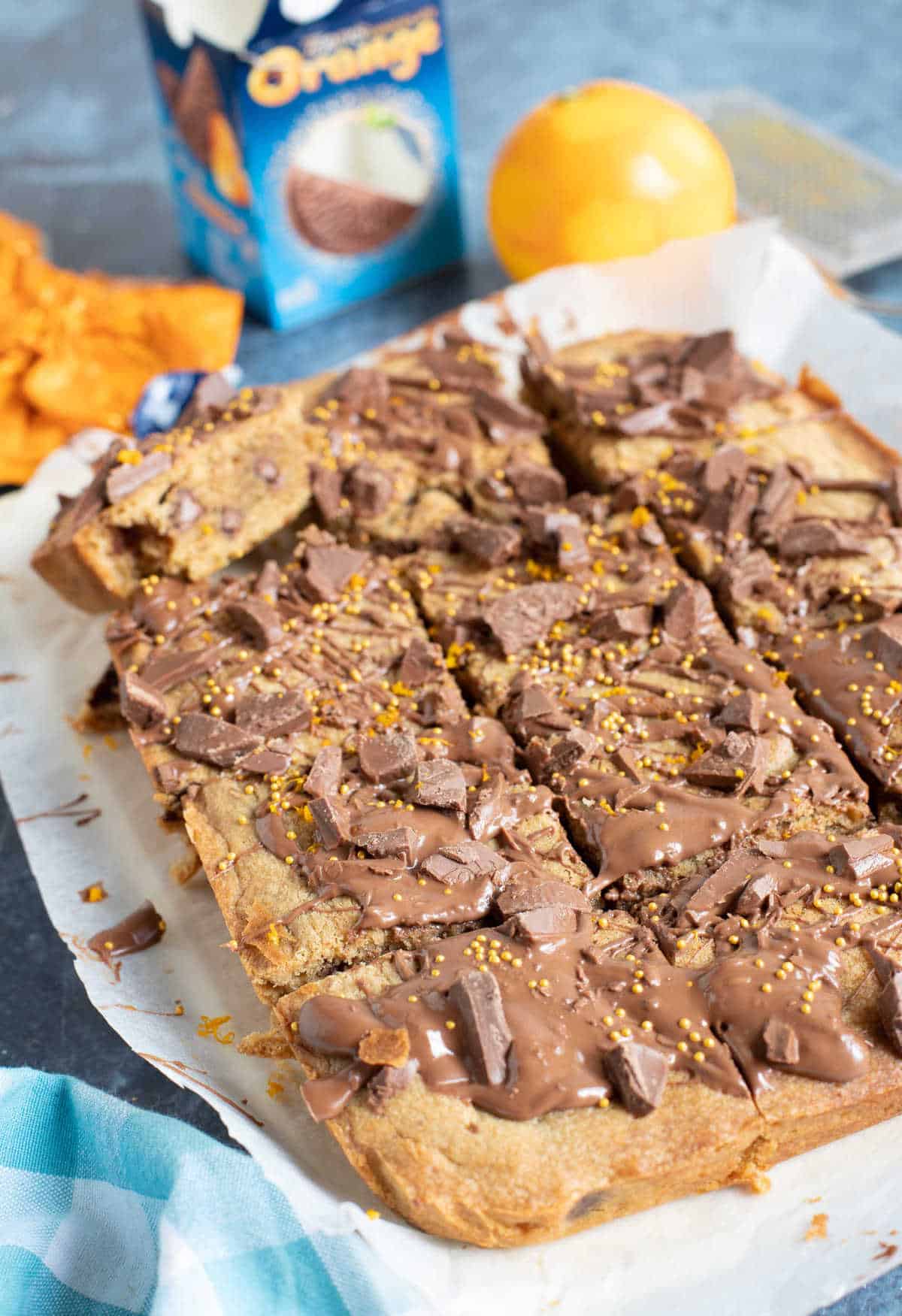 Chocolate orange cookie bars cut into squares on a board.