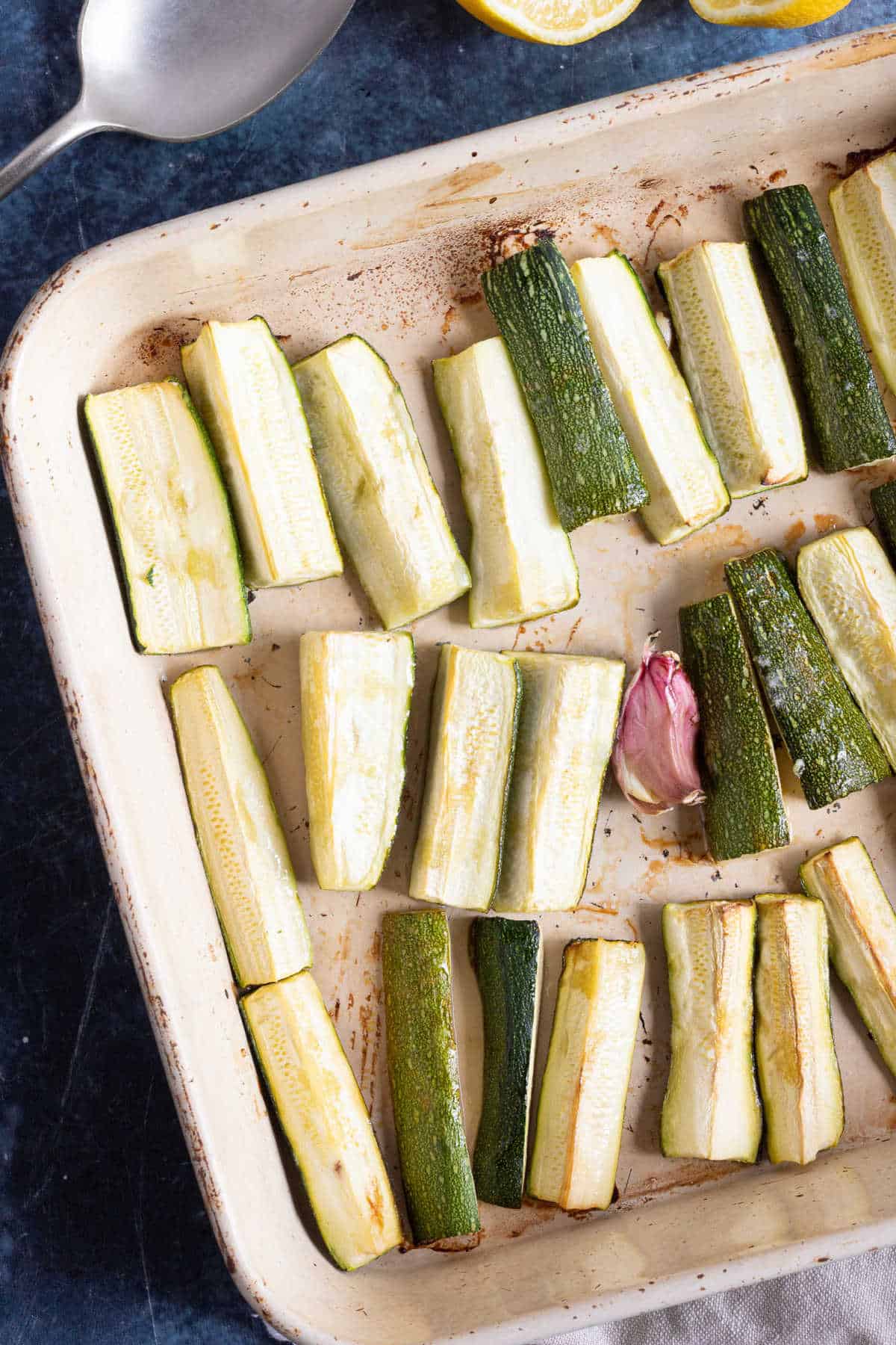 Roast courgettes in baking tin.