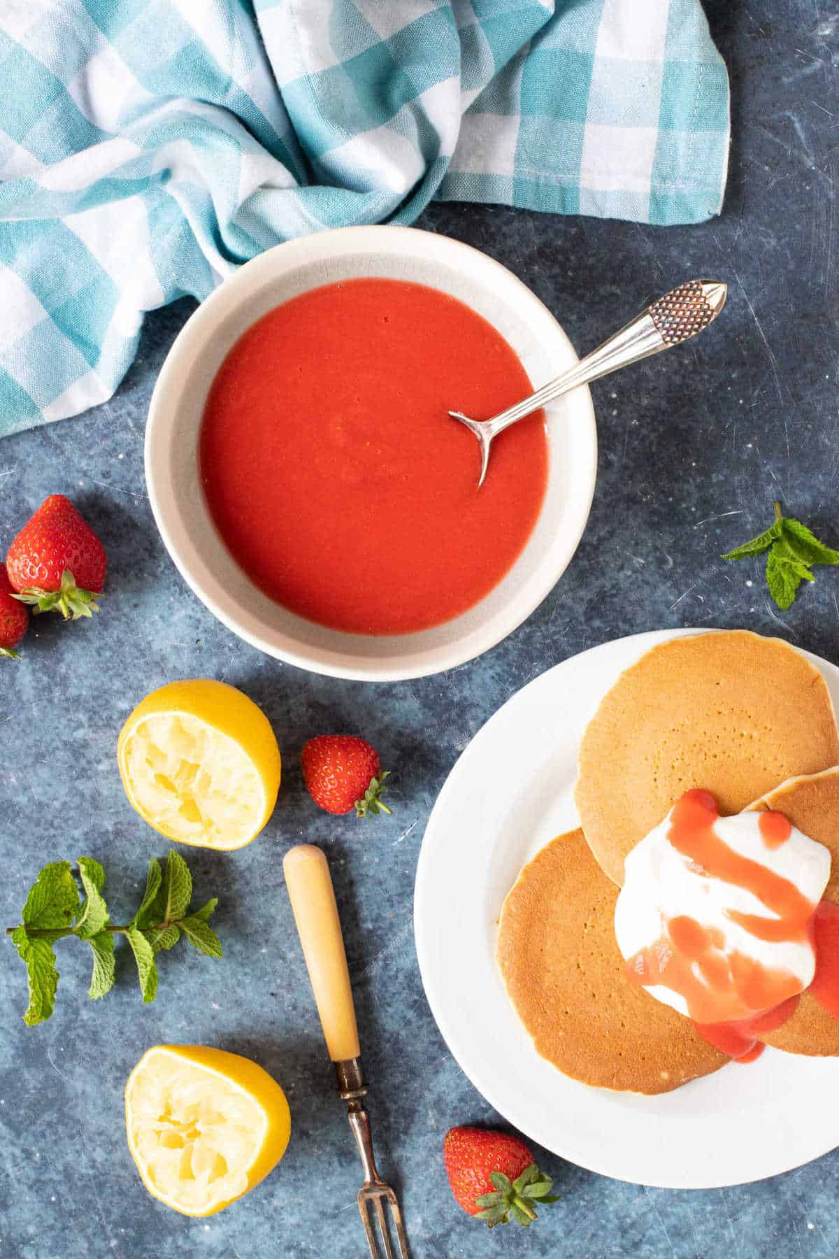 Strawberry coulis in a bowl and drizzled over pancakes.