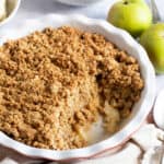 Easy cinnamon apple crumble in a pie dish.