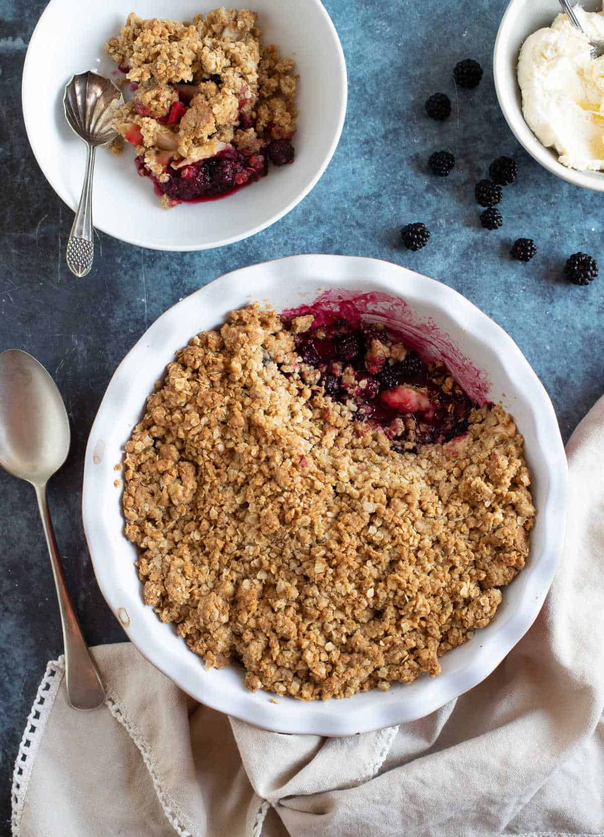 Blackberry crumble with whipped cream.