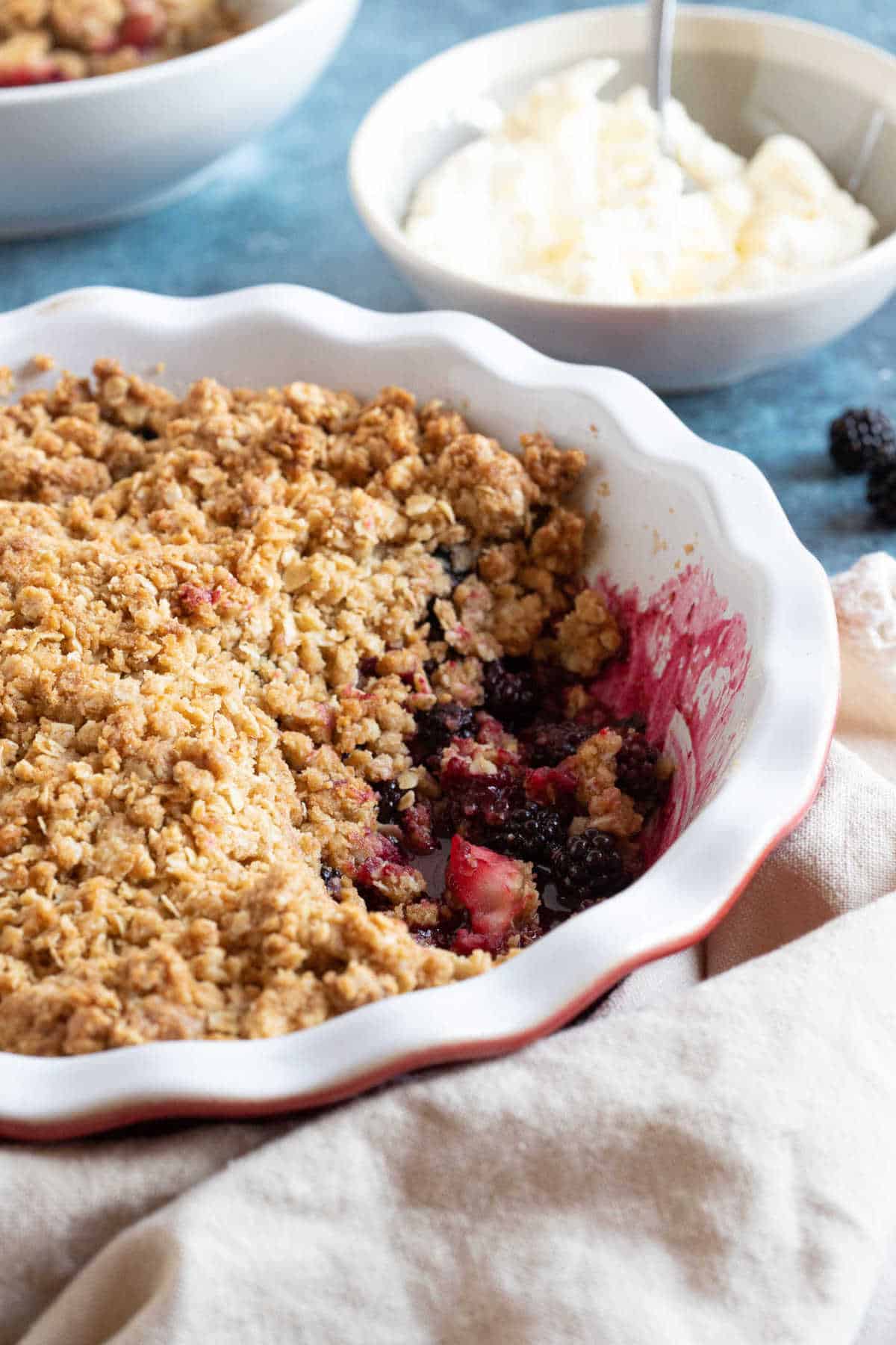 Blackberry and apple crumble with cream.