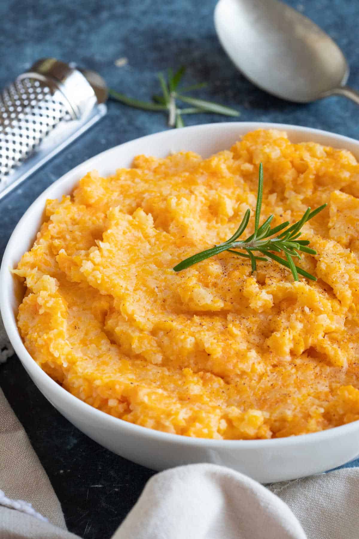 A bowl of creamy carrot and swede mash.