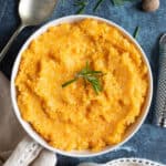 A bowl of carrot and swede mash.