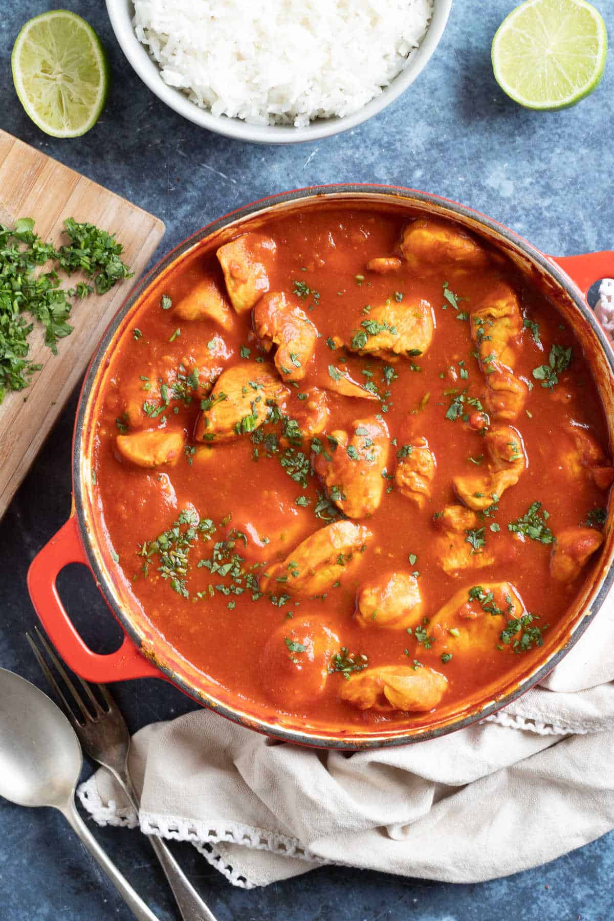 Chicken pathia curry in a red pan.