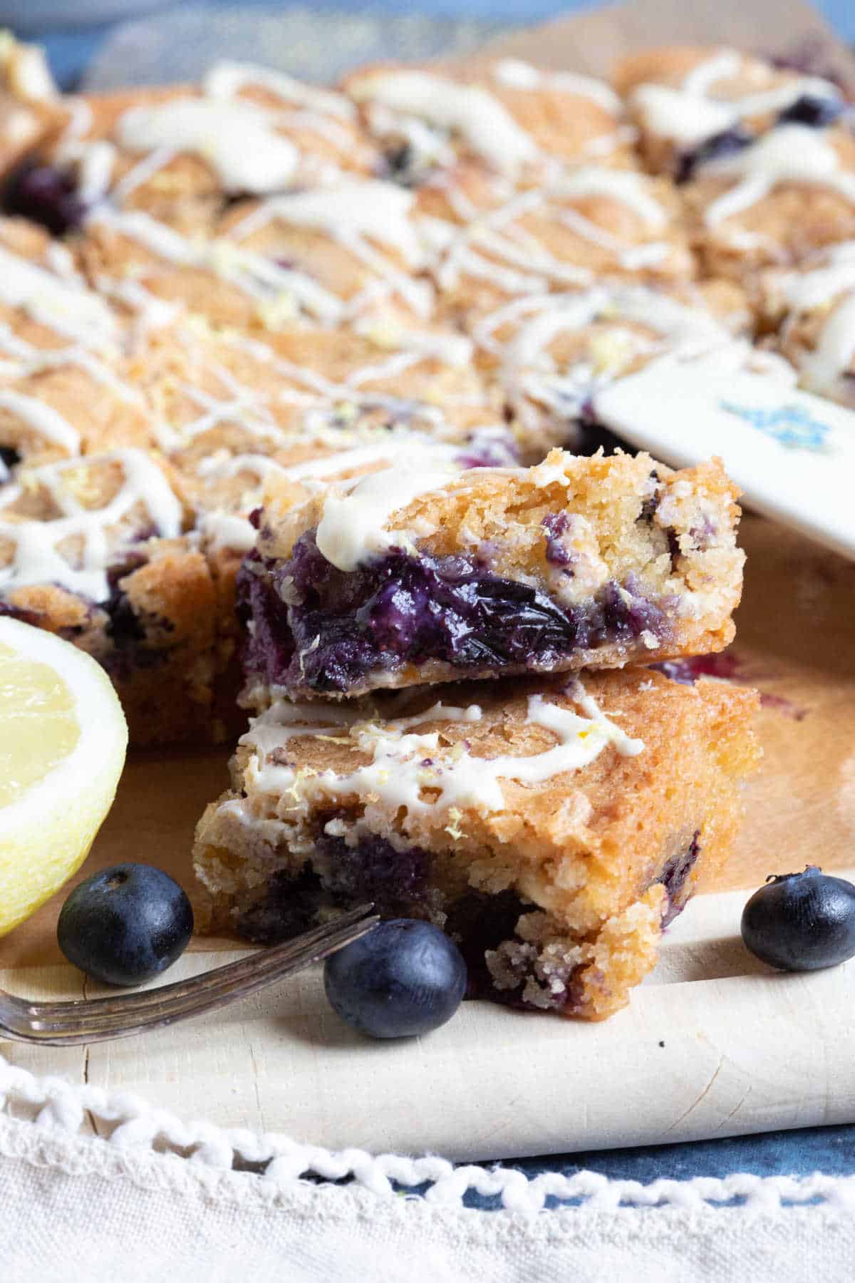 Blueberry and lemon blondies with white chocolate drizzle.