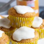 A stack of pumpkin muffins in a cake stand.