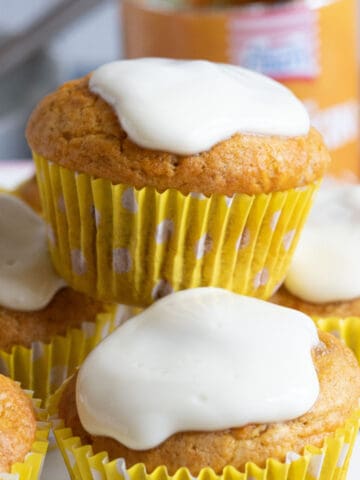 A stack of pumpkin muffins in a cake stand.