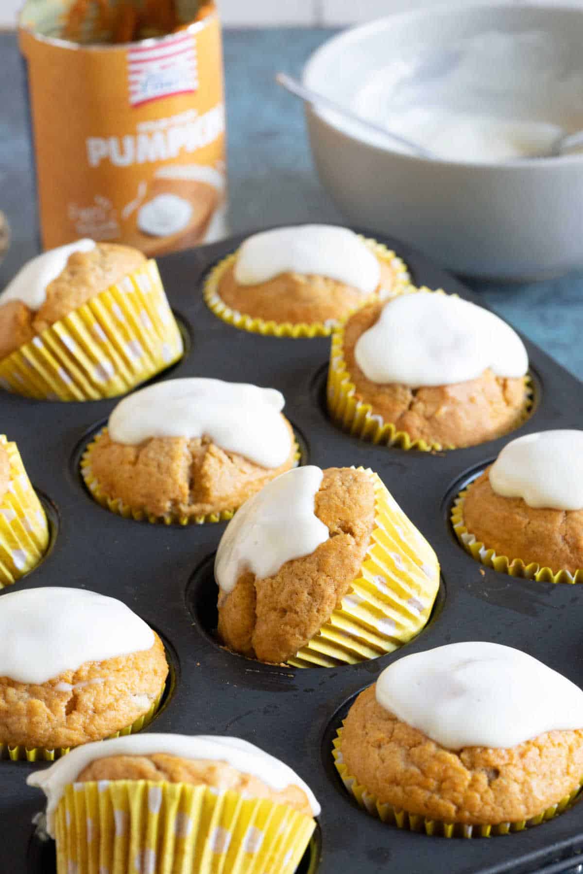 A stack of pumpkin muffins on a cake stand.