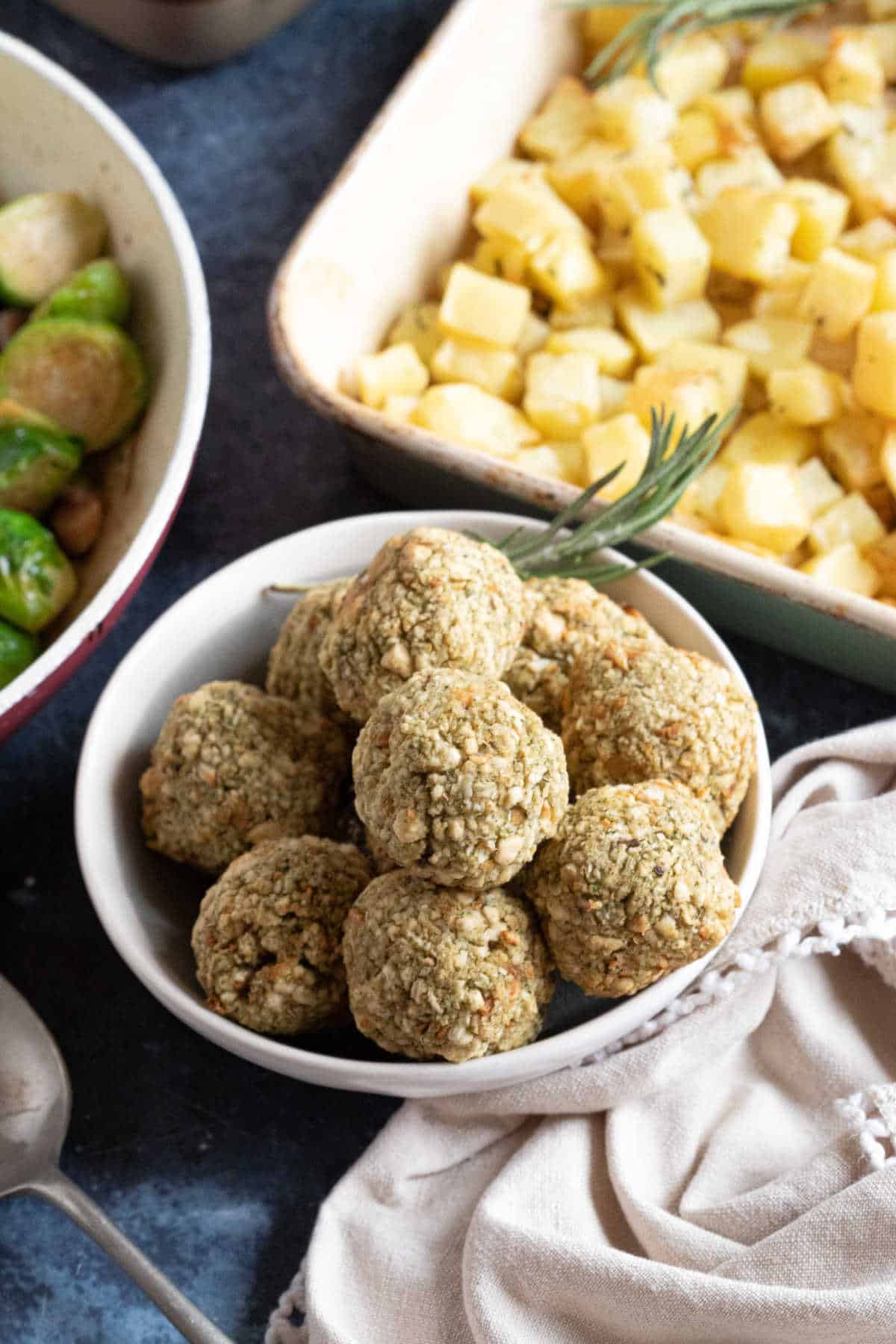 Air fryer sage and onion stuffing balls  with potatoes and brussels sprouts.