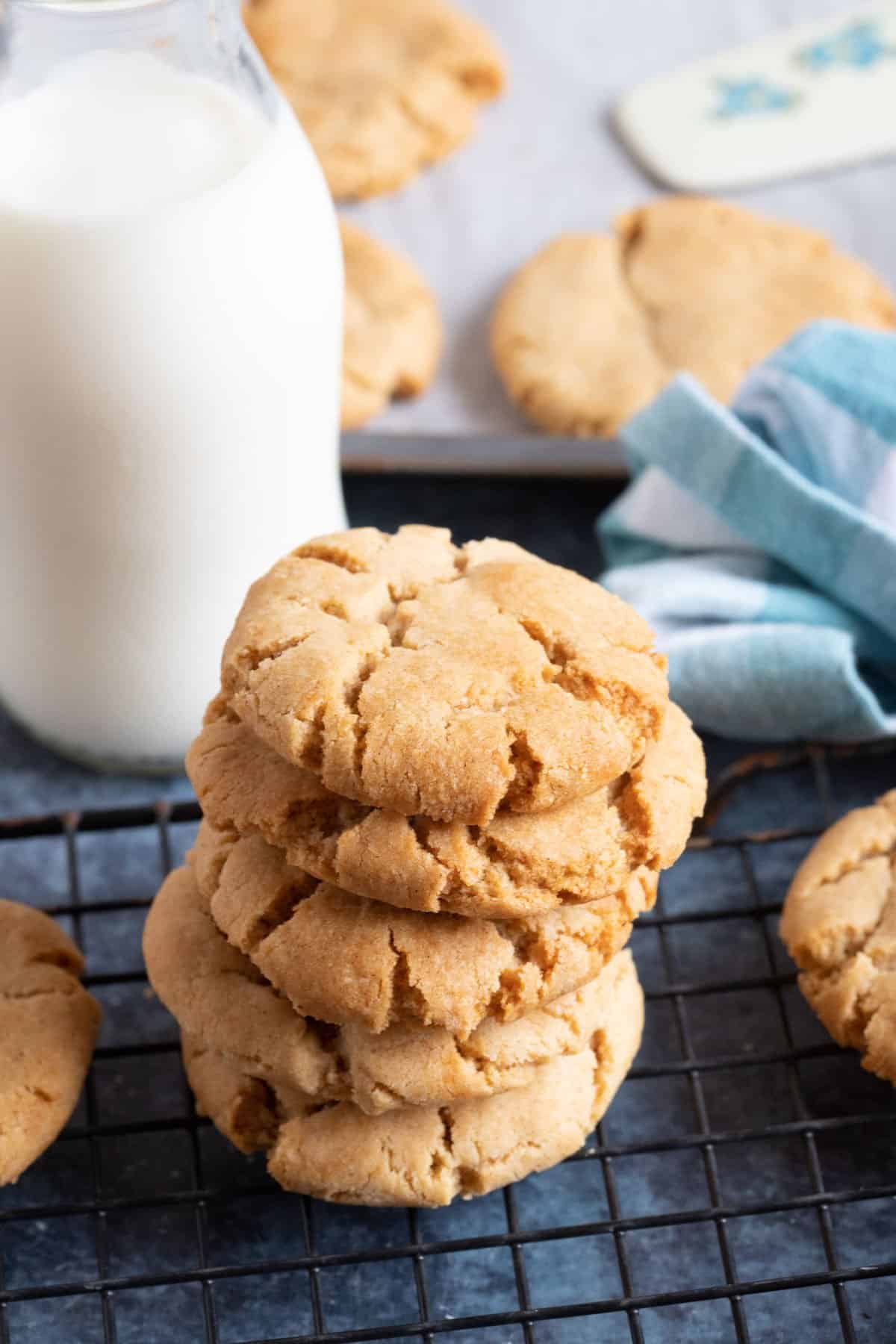 Ginger biscuits stacked on a cooling rack.