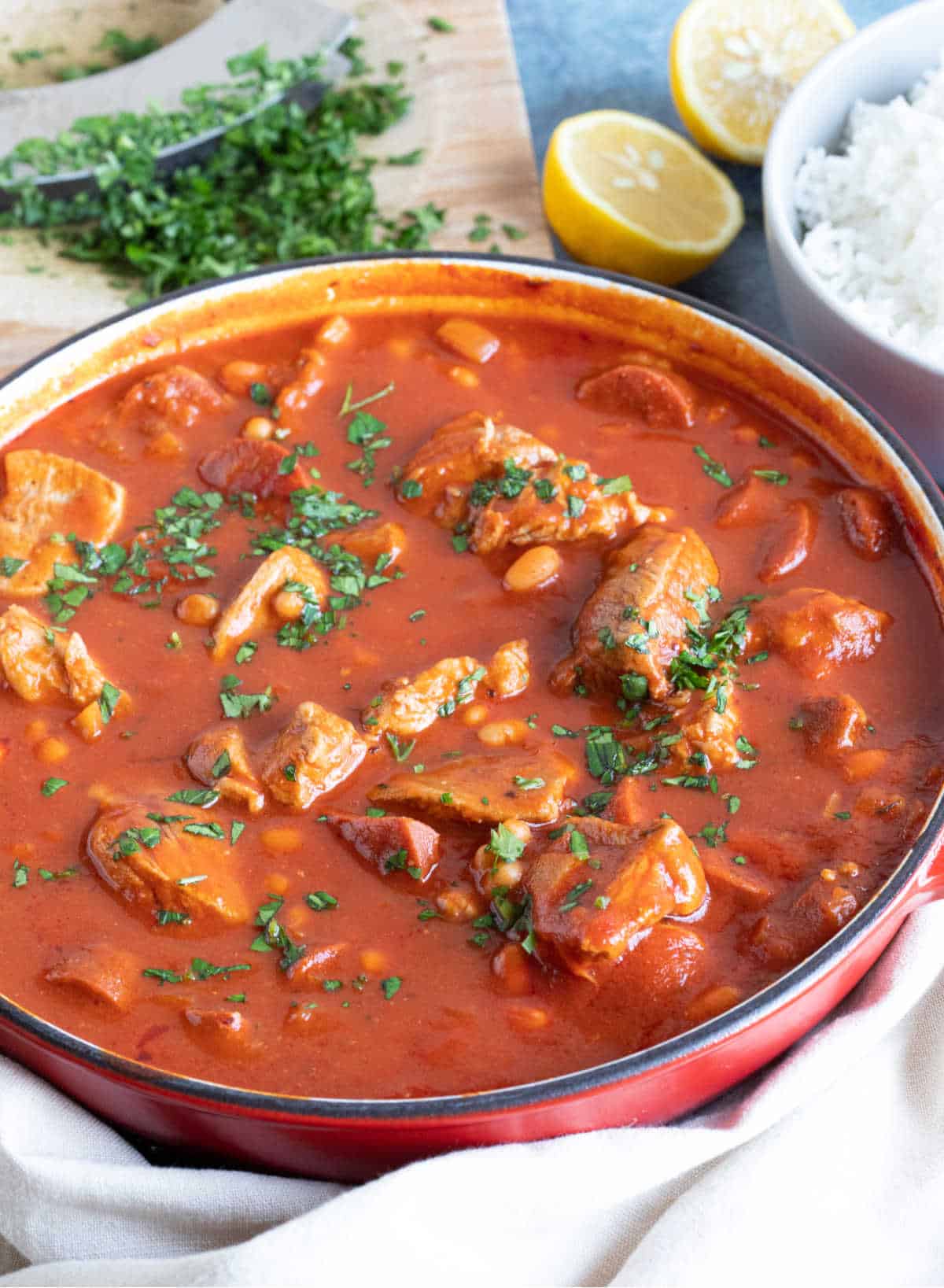 Pork and chorizo stew garnished with parsley.