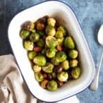 Roasted Brussels Sprouts in a white baking dish.