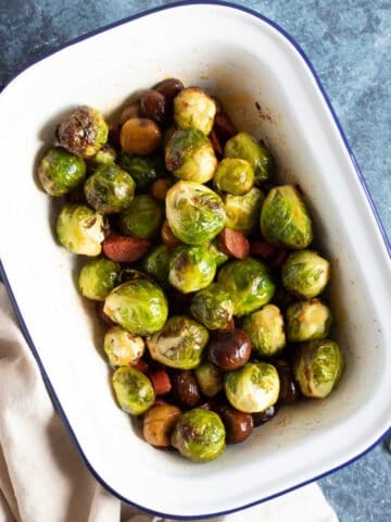 Roasted Brussels Sprouts in a white baking dish.