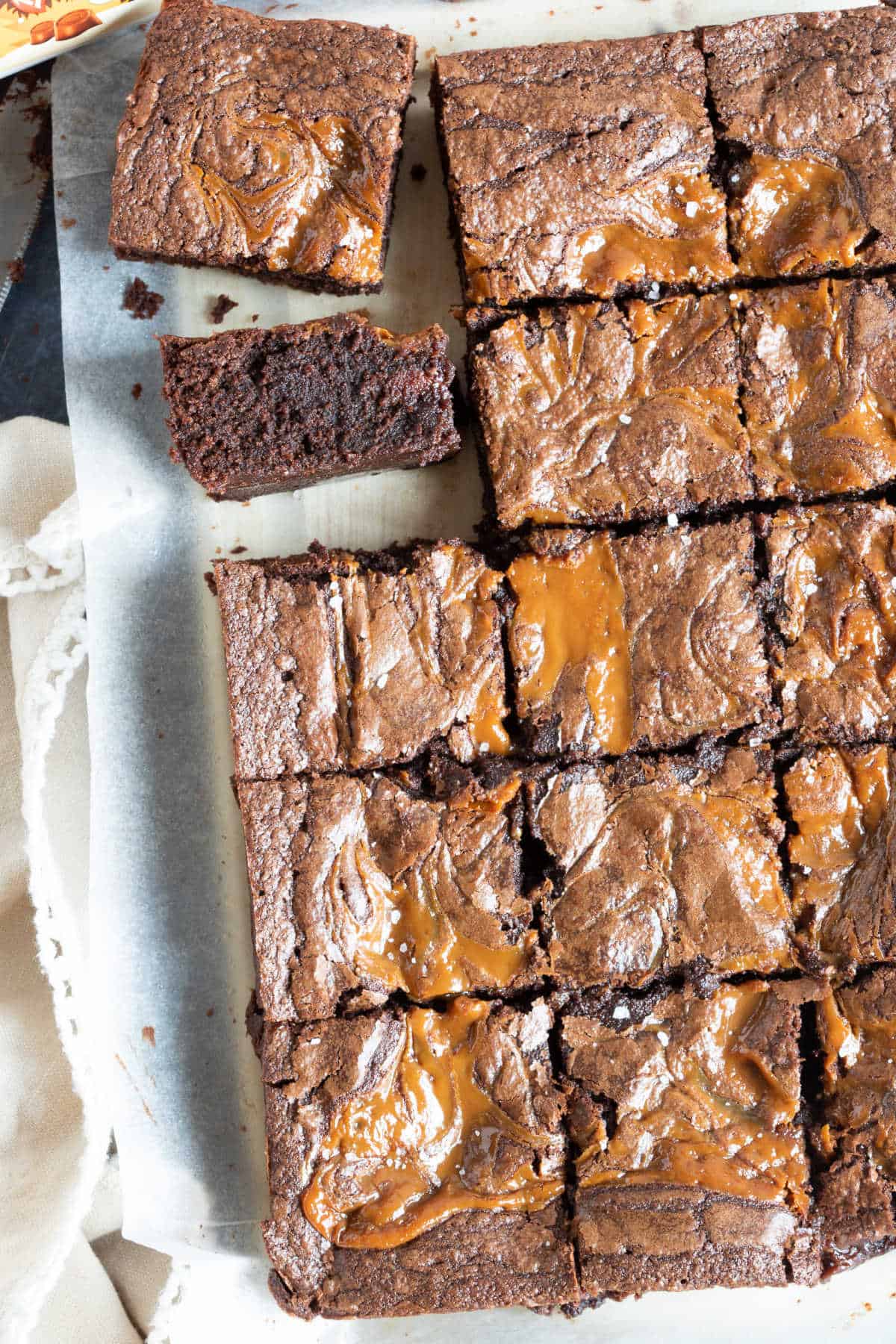 Rolo brownies being sliced into bars.