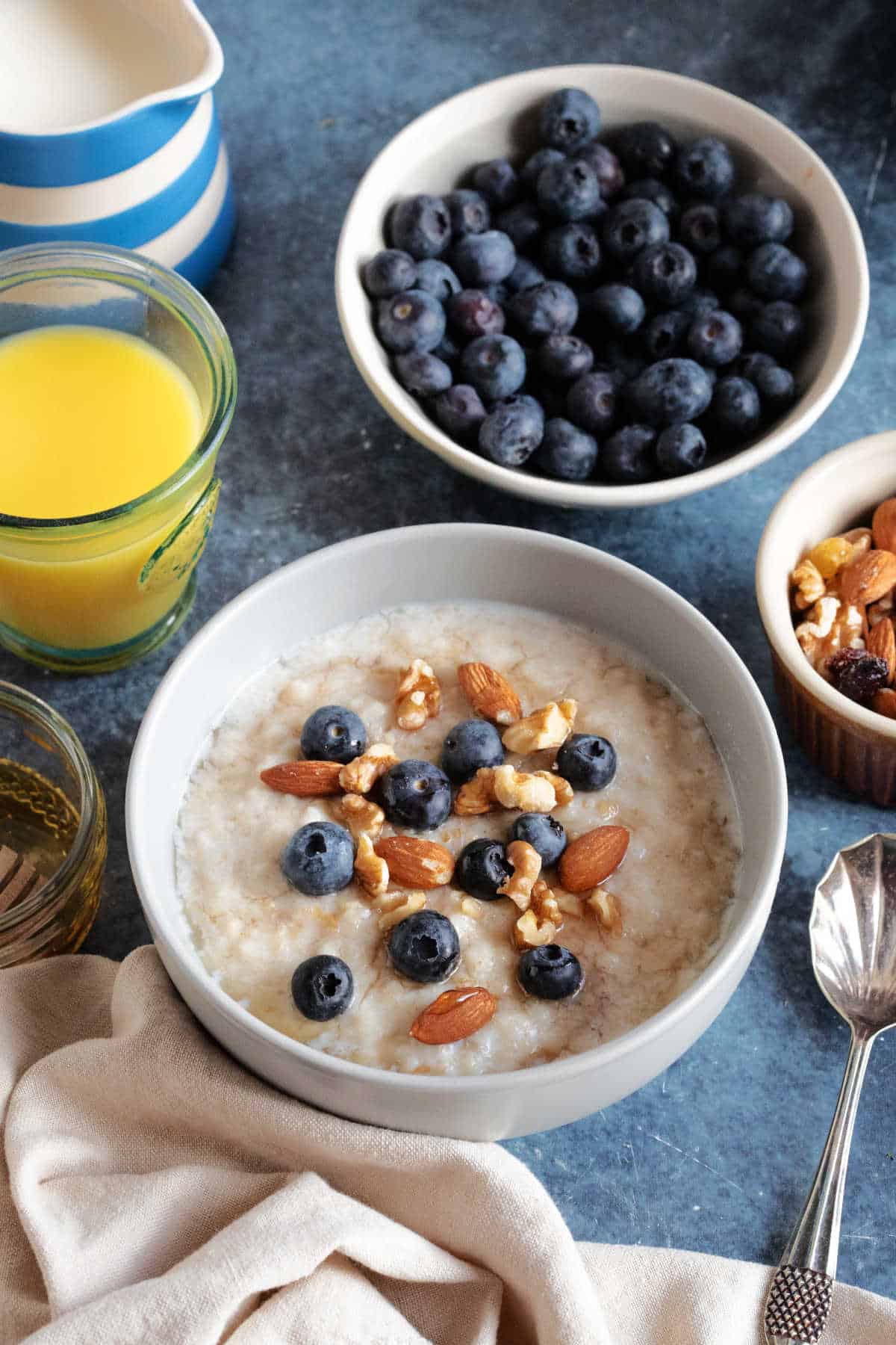 A bowl of slow cooker porridge with blueberries, nuts and honey.