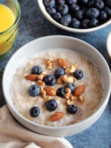 A bowl of slow cooker porridge with blueberries.