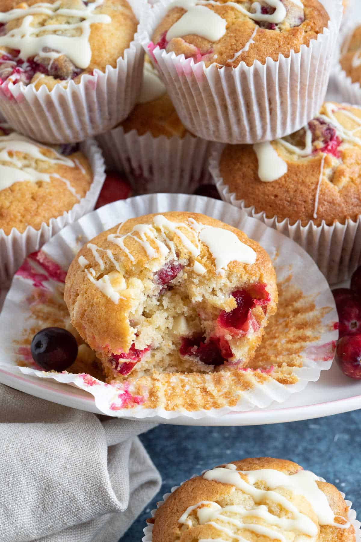 Cranberry white chocolate muffins on a cake stand.
