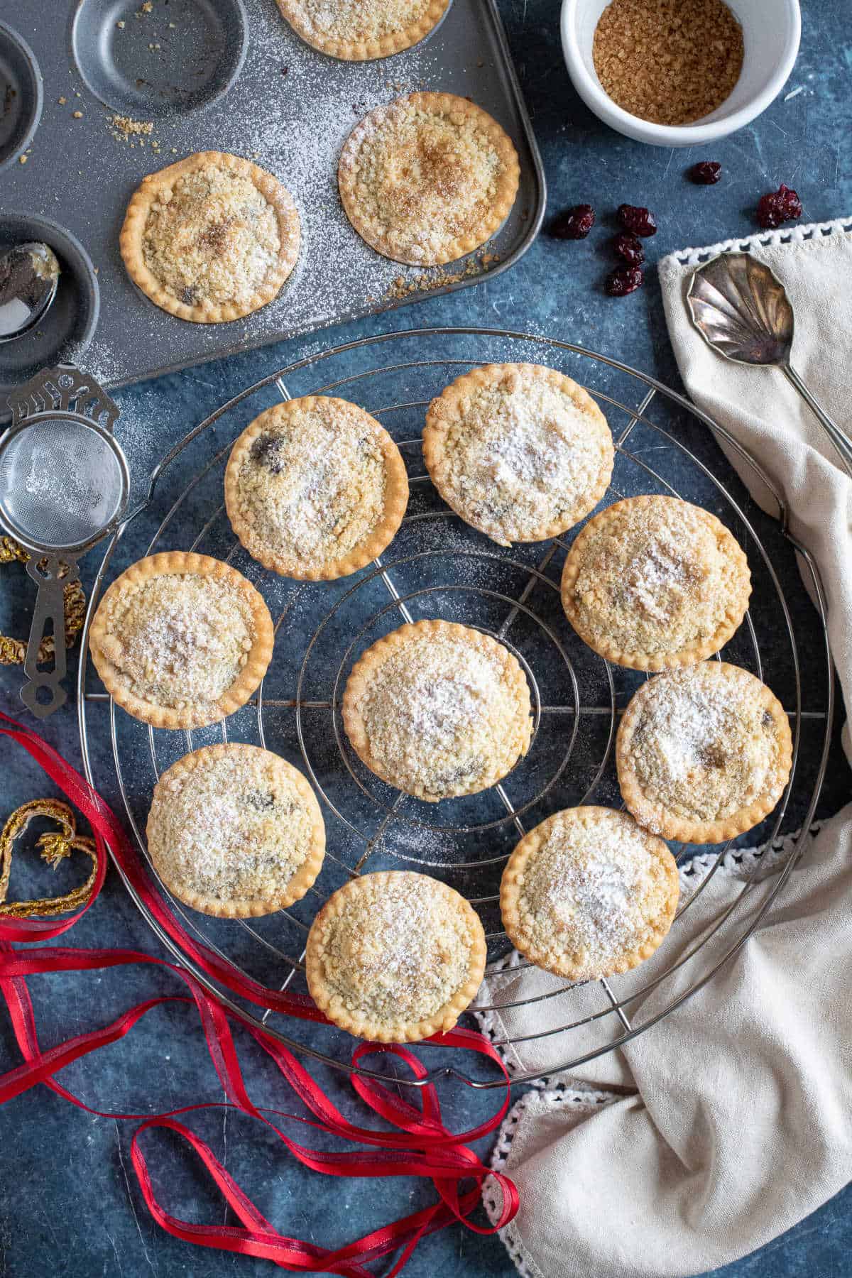 Crumble topped mince pies dusted with icing sugar.