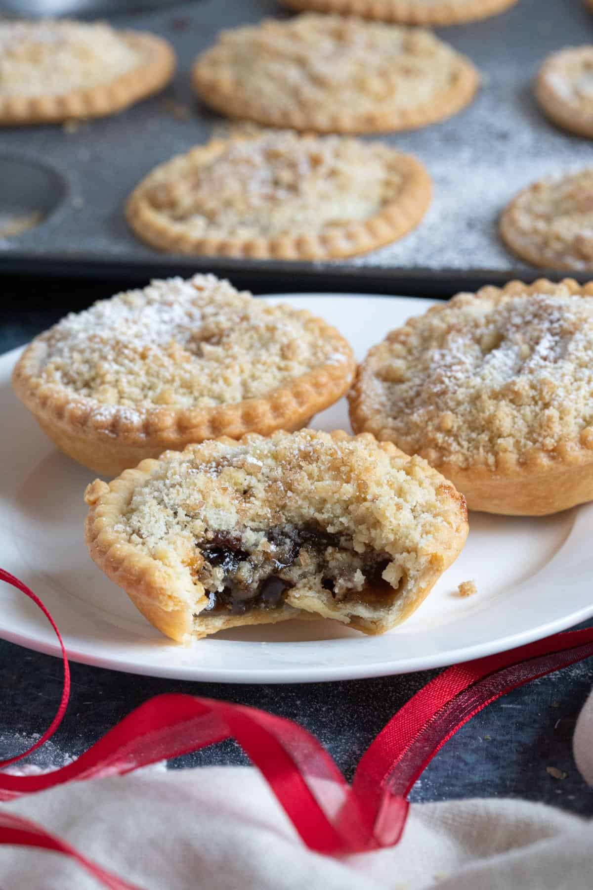 Crumble topped mince pies on a plate.