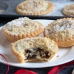 Crumble topped mince pies on a plate.