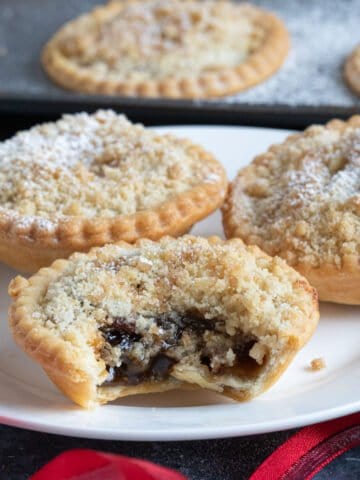 Crumble topped mince pies on a plate.