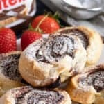 Nutella puff pastry swirls on a plate.