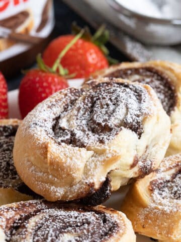Nutella puff pastry swirls on a plate.