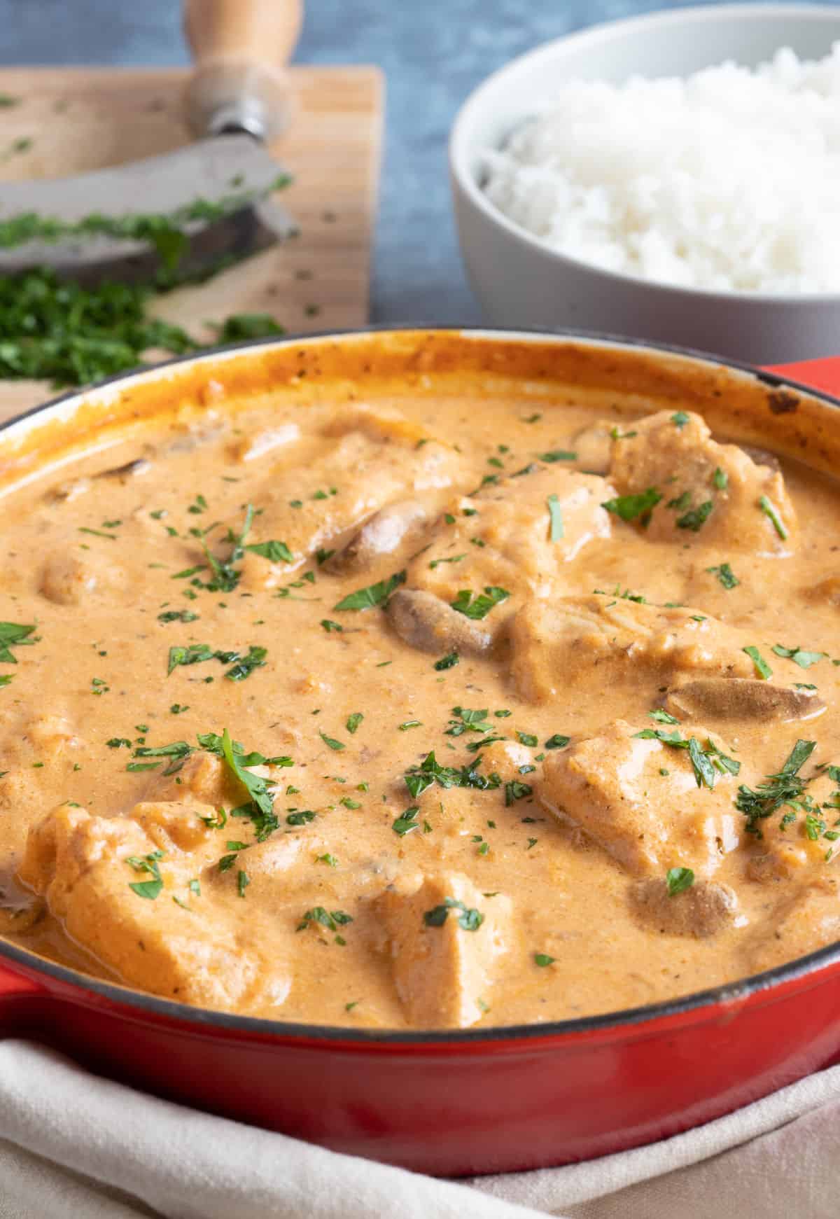 Pork stroganoff in a red casserole.