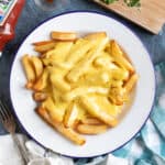 A plate of cheesy chips.