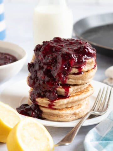 Frozen berry compote spooned over pancakes.