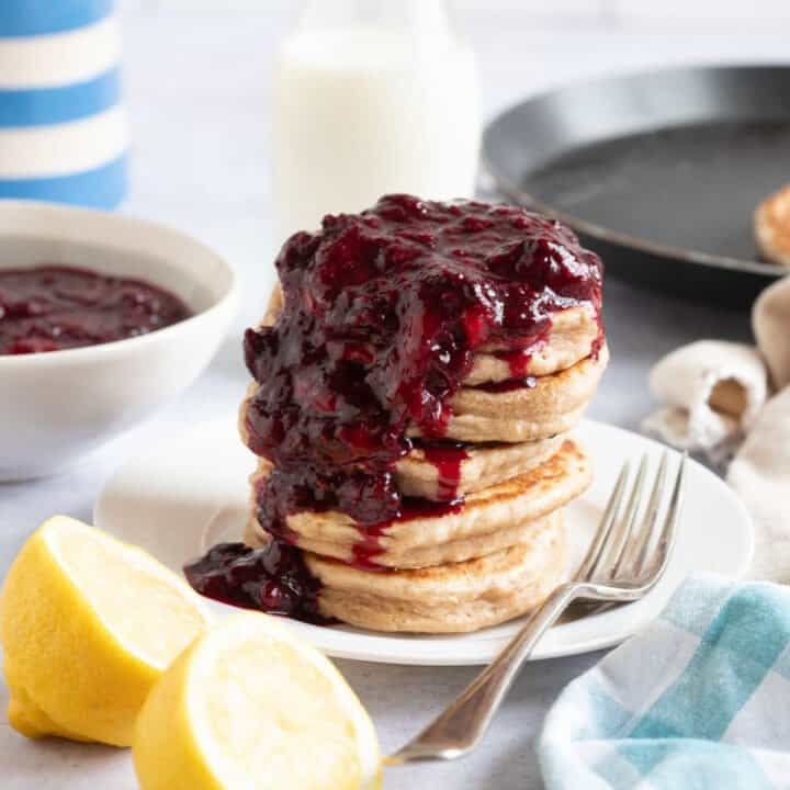 Frozen berry compote spooned over pancakes.