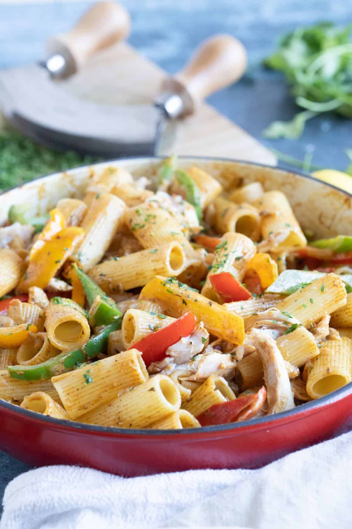 A pan of rasta pasta with sauteed bell peppers and chicken.