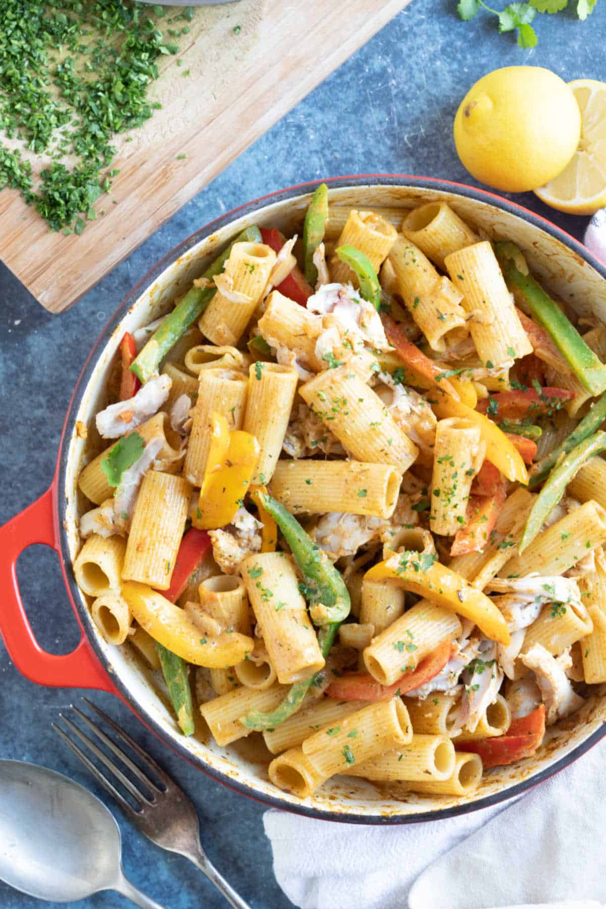 Rasta pasta in a red pan with chicken.