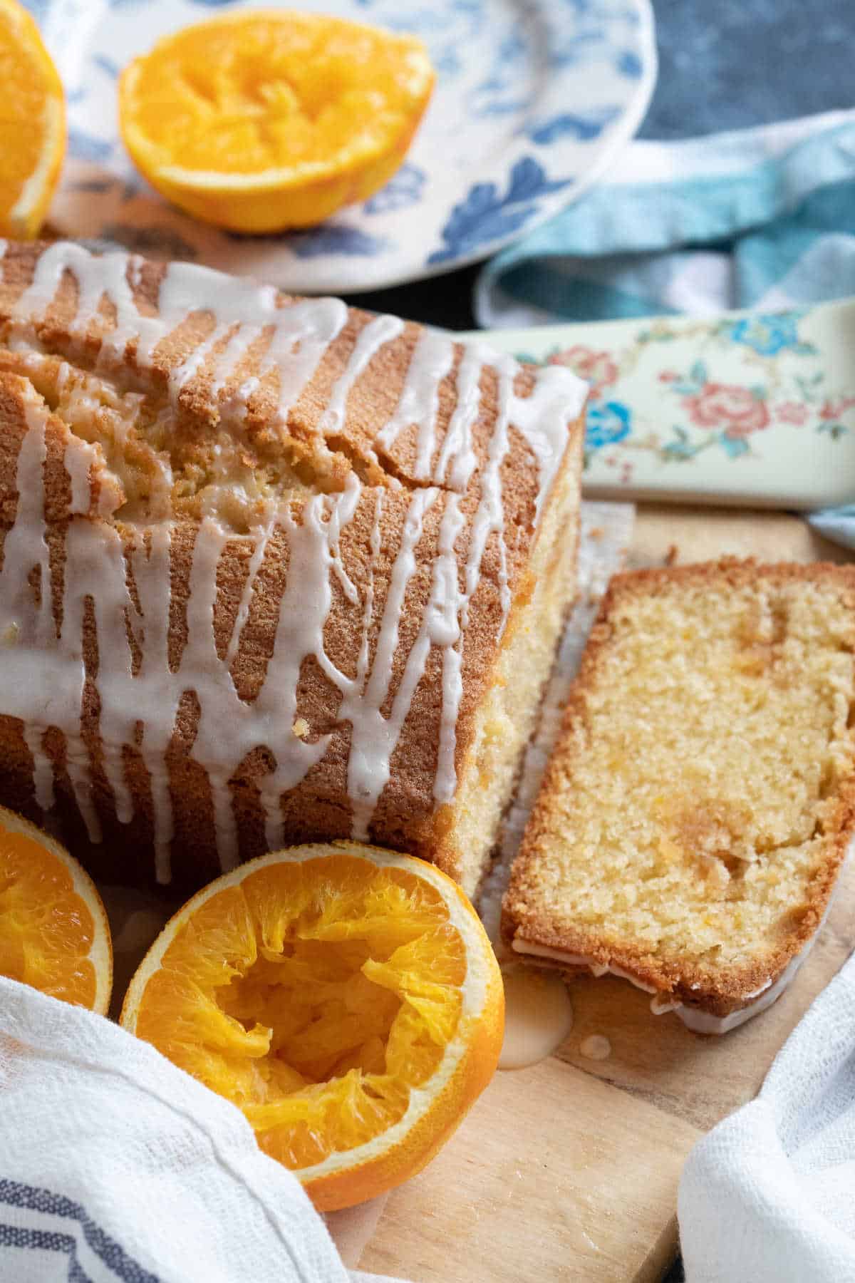 Marzipan loaf cake with a slice cut off the end so you can see the light almond sponge.