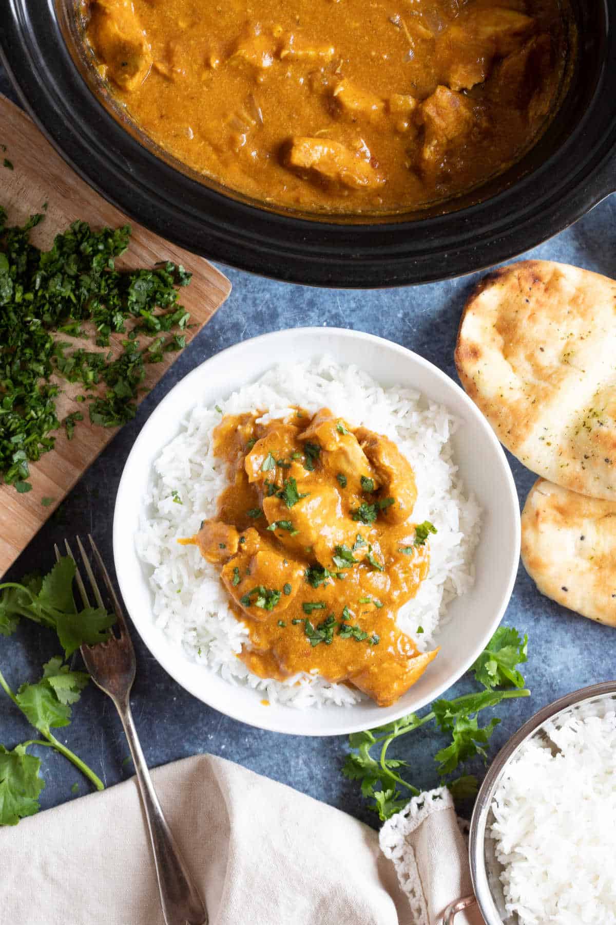 Slow cooker chicken curry in a bowl with rice.