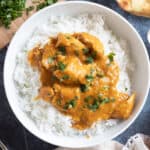 Slow cooker chicken curry garnished with chopped coriander.