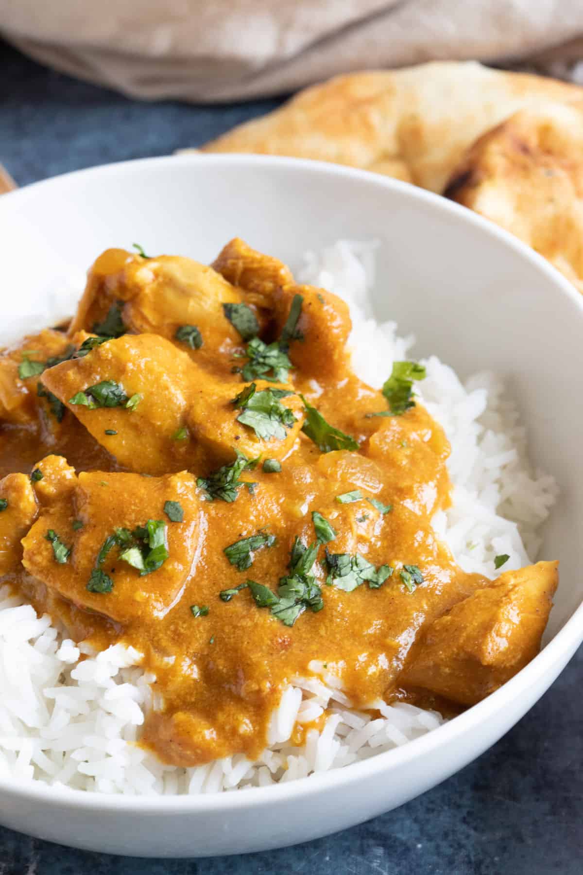 Mild slow cooker chicken curry in a white bowl.
