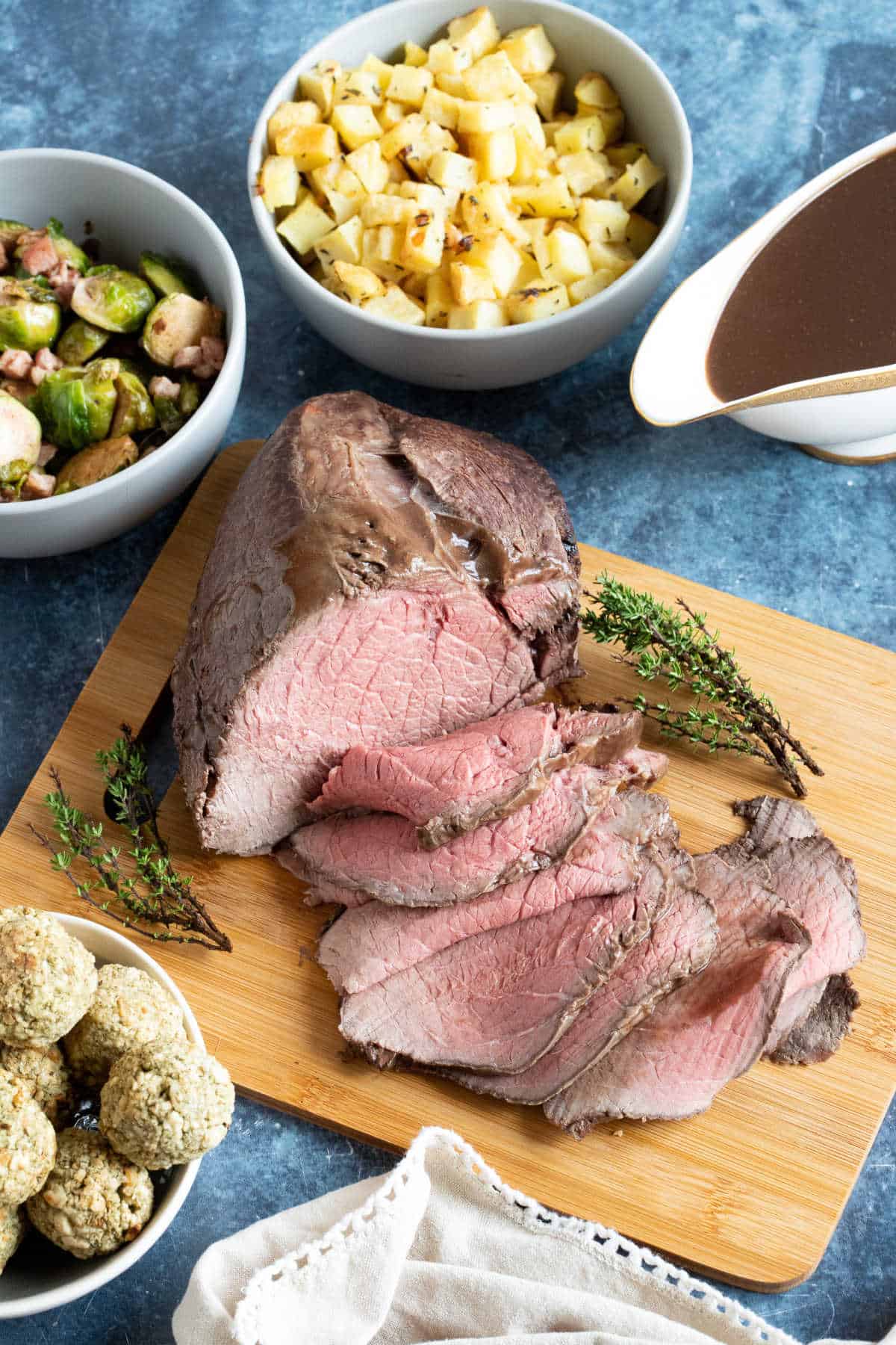 Roast beef dinner with side dishes.