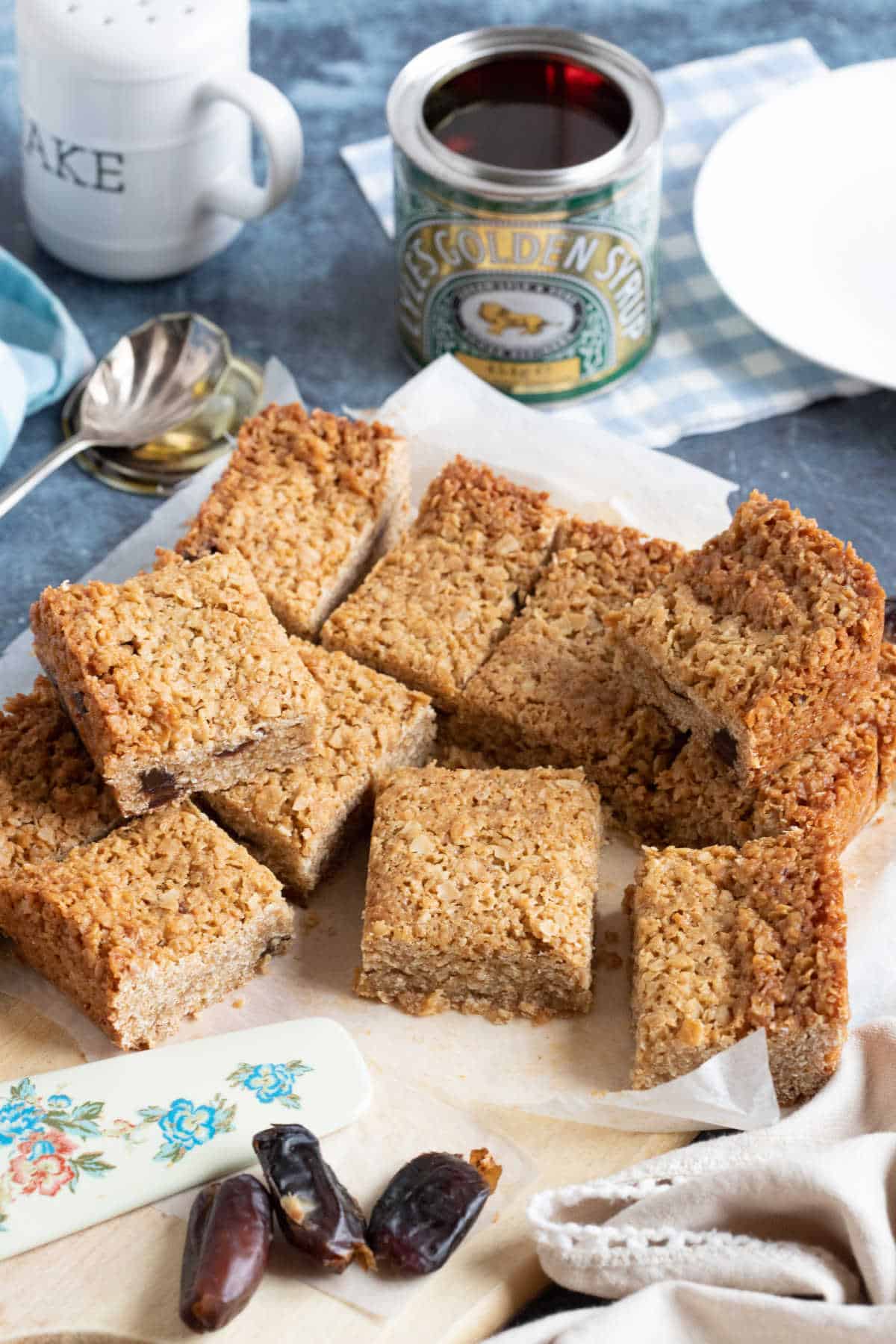 Squidgy flapjacks cut into neat bars on a wooden board.