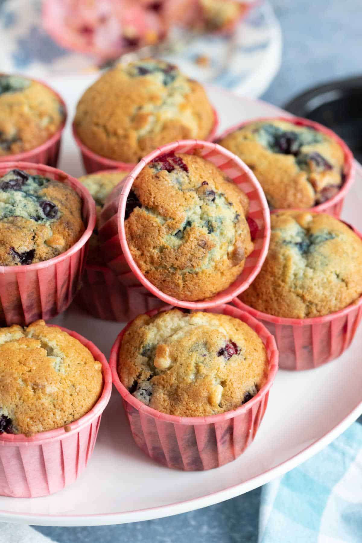 Blackcurrant muffins on a cake stand.