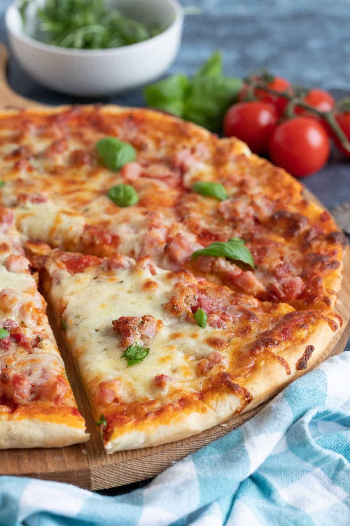 A slice of pizza on a cutting board.