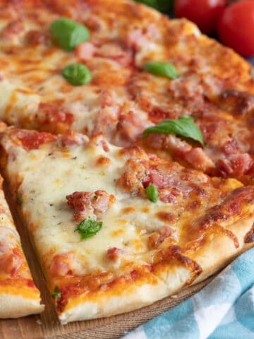 Slice of meat feast pizza.