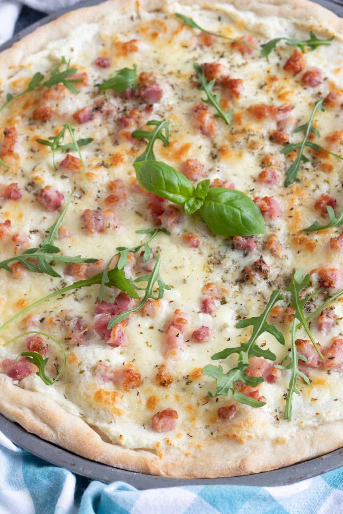 White pizza with pancetta and rocket.