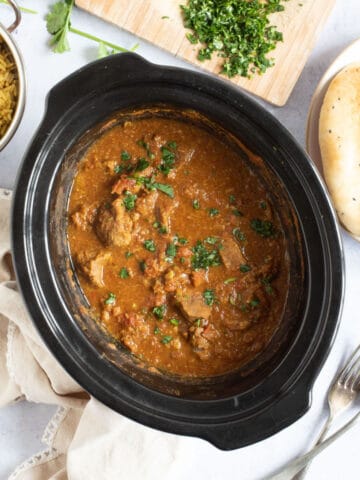 Slow cooker beef curry in a slow cooker.